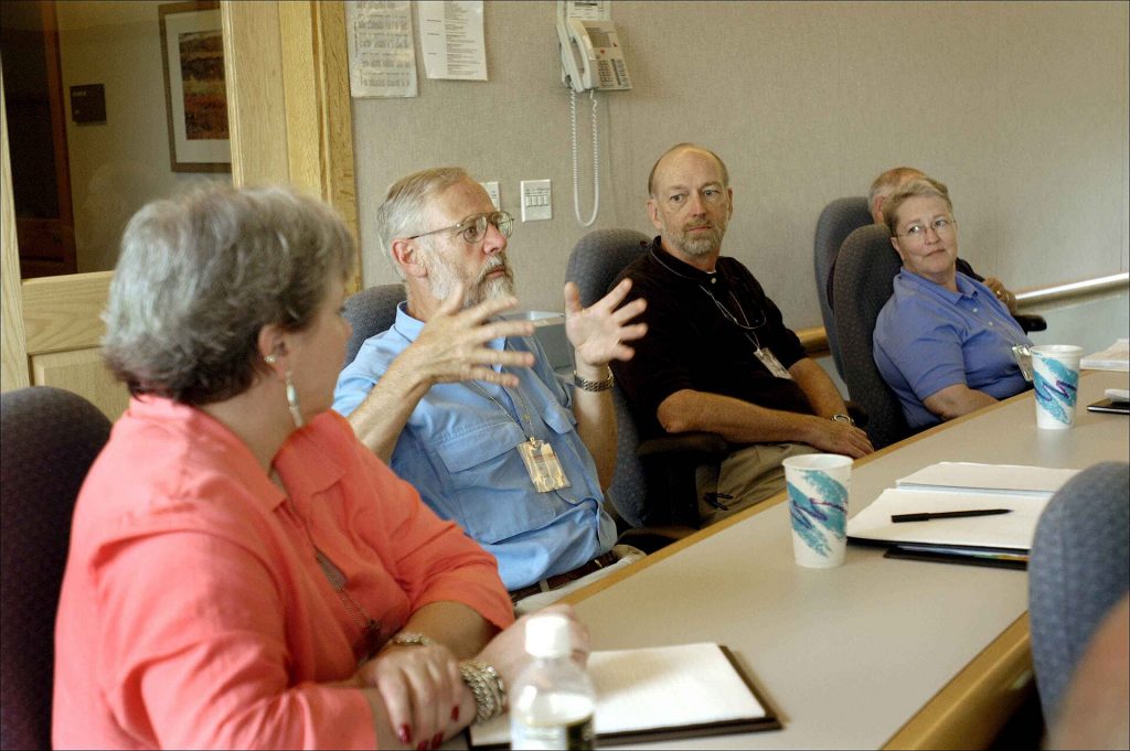 People seated around a conference table in a business meeting
