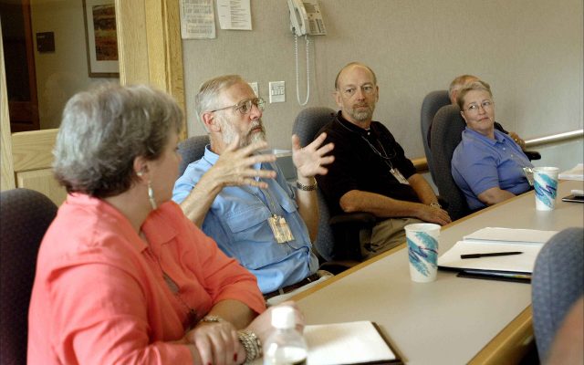 People seated around a conference table in a business meeting