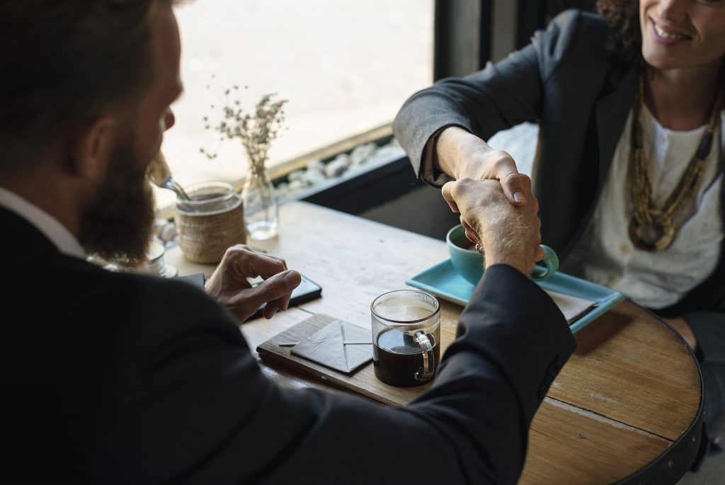 Two business partners shaking hands to seal an agreement