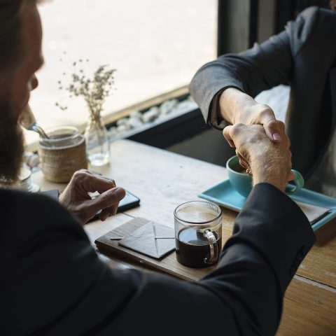 Two business partners shaking hands to seal an agreement