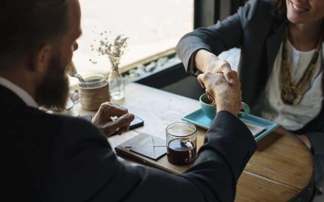 Two business partners shaking hands to seal an agreement