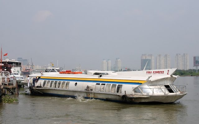 A hydrofoil passenger vessel lifted above the water at speed