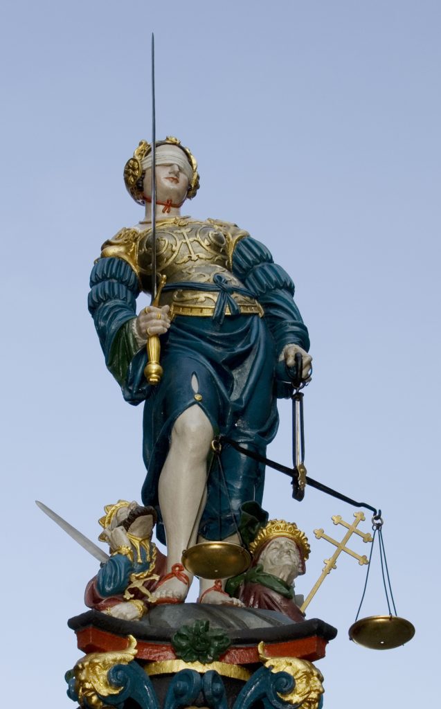 Statue of Lady Justice holding scales and sword atop the Justice Fountain in Bern