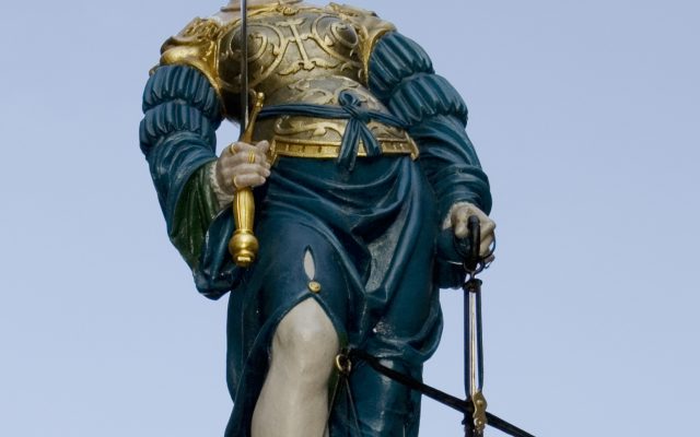 Statue of Lady Justice holding scales and sword atop the Justice Fountain in Bern