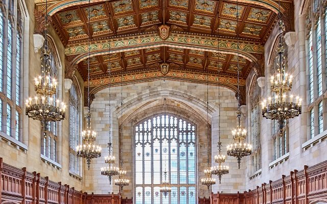 Reading room of the University of Michigan law library with shelves of books