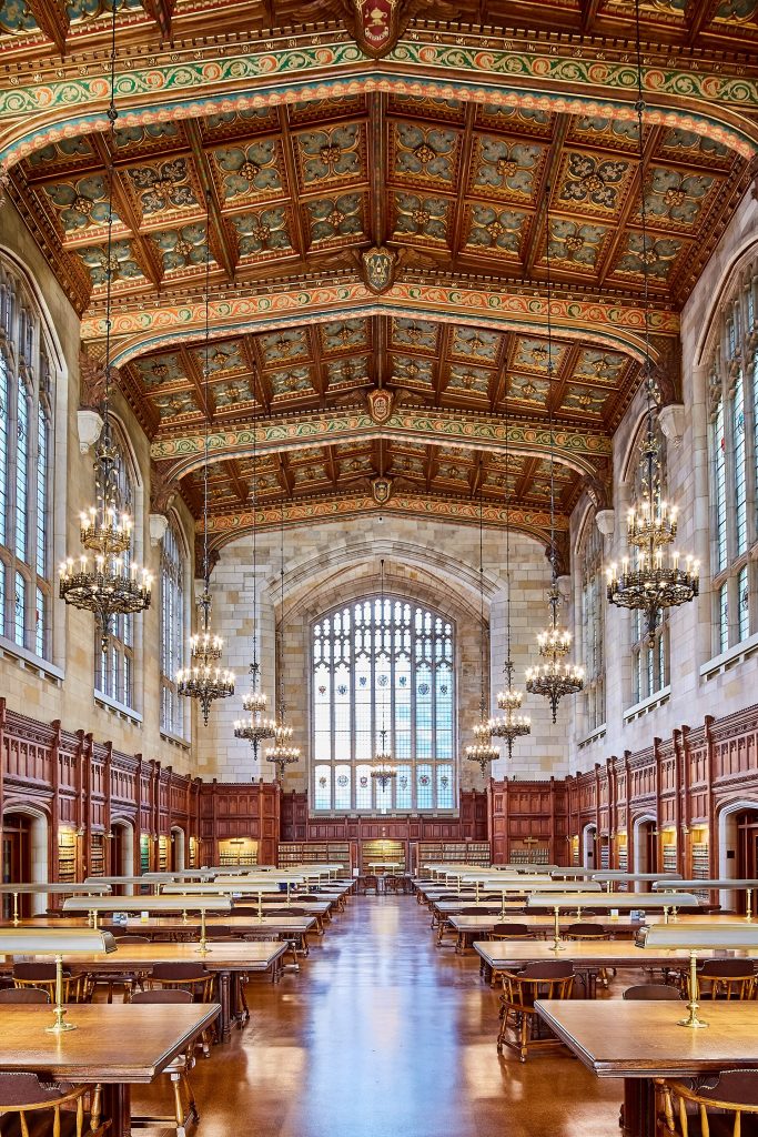 Reading room of the University of Michigan law library with shelves of books